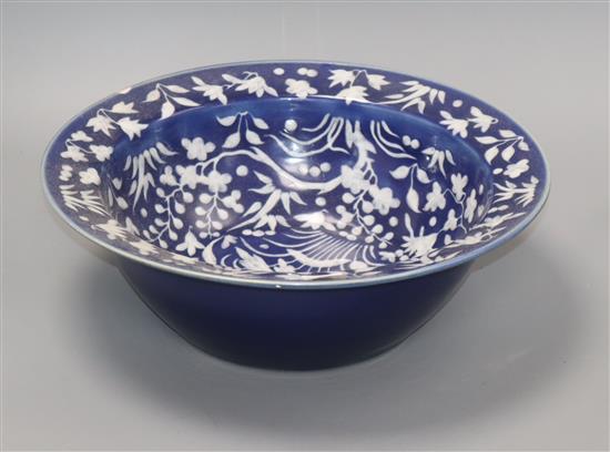 A 19th century Chinese white slip decorated blue ground basin diameter 34cm
